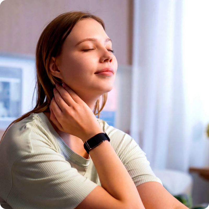 A woman with her eyes closed checking the pulse at her neck, wearing the HLTH Band