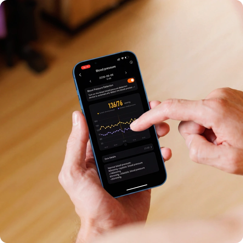 A hand holding a phone showing HLTH Band health trends in the app