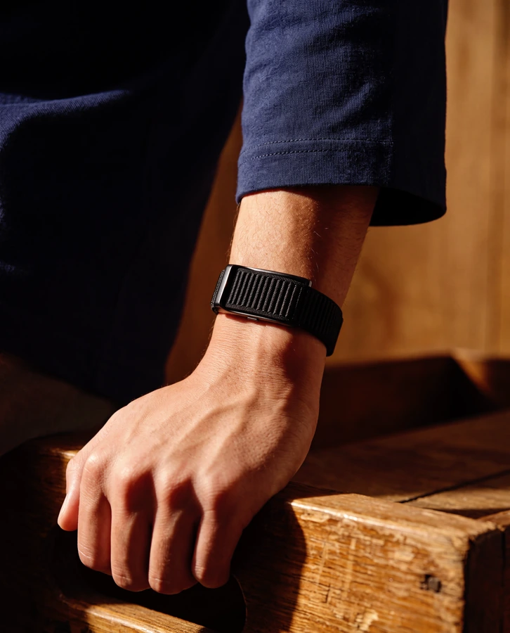 Daniel taking a quiet moment during a busy day, wearing the HLTH Band